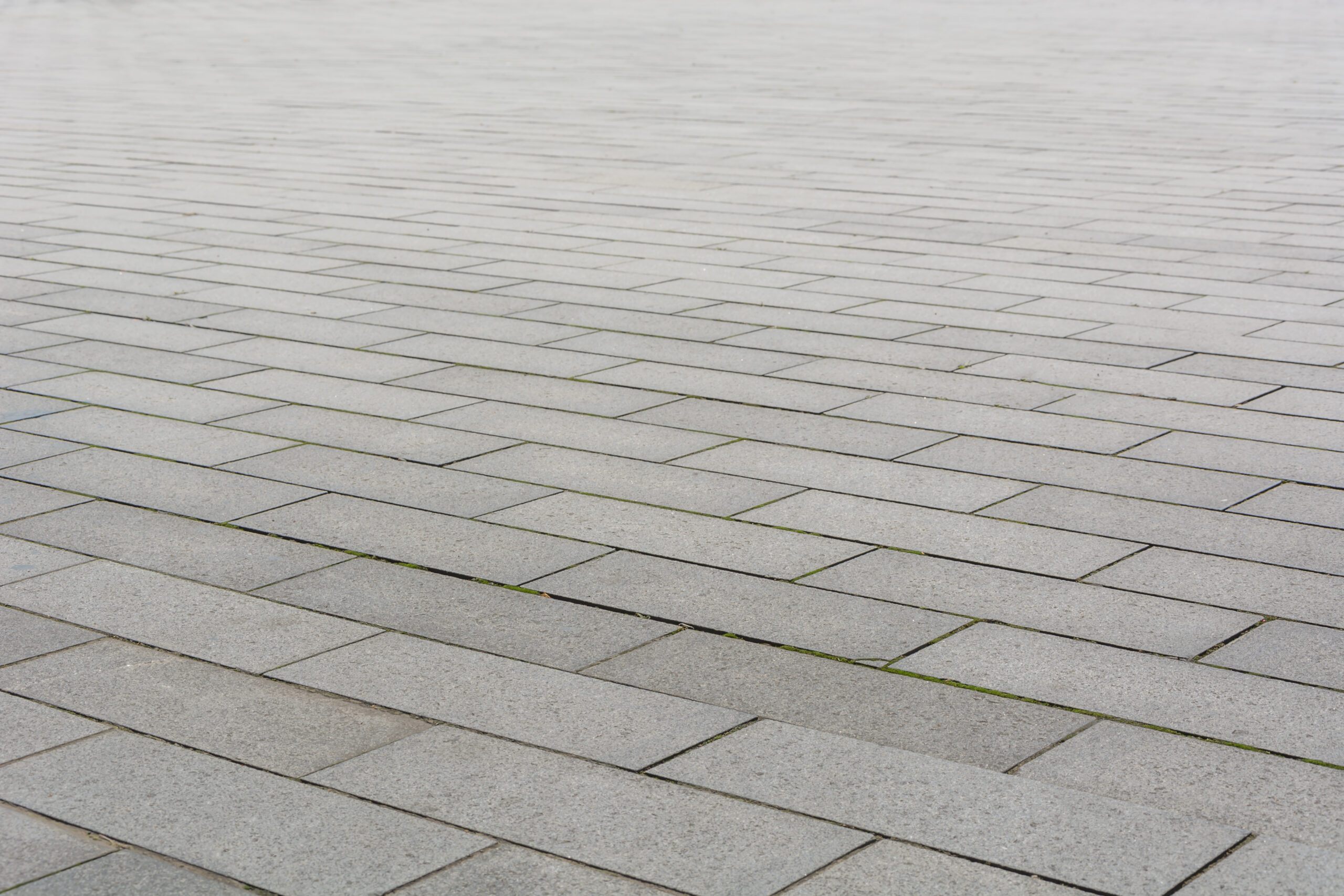 Grey brick stone street road. Light sidewalk, pavement texture